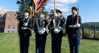 An image of military students presenting the colors at a campus event.